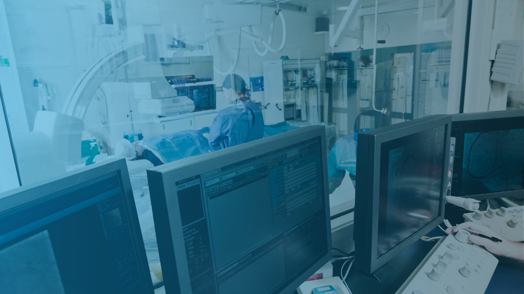 Vascular lab technologist analyzing ultrasound images before digital upgrade.